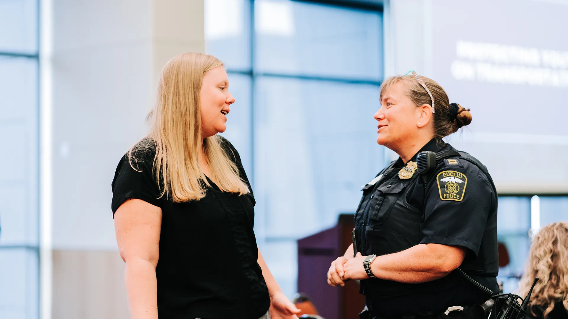 Lexi speaks to an officer at the 2024 Cleveland, Ohio Coalition Build