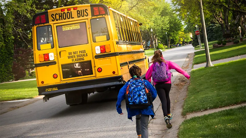 Children running for school bus