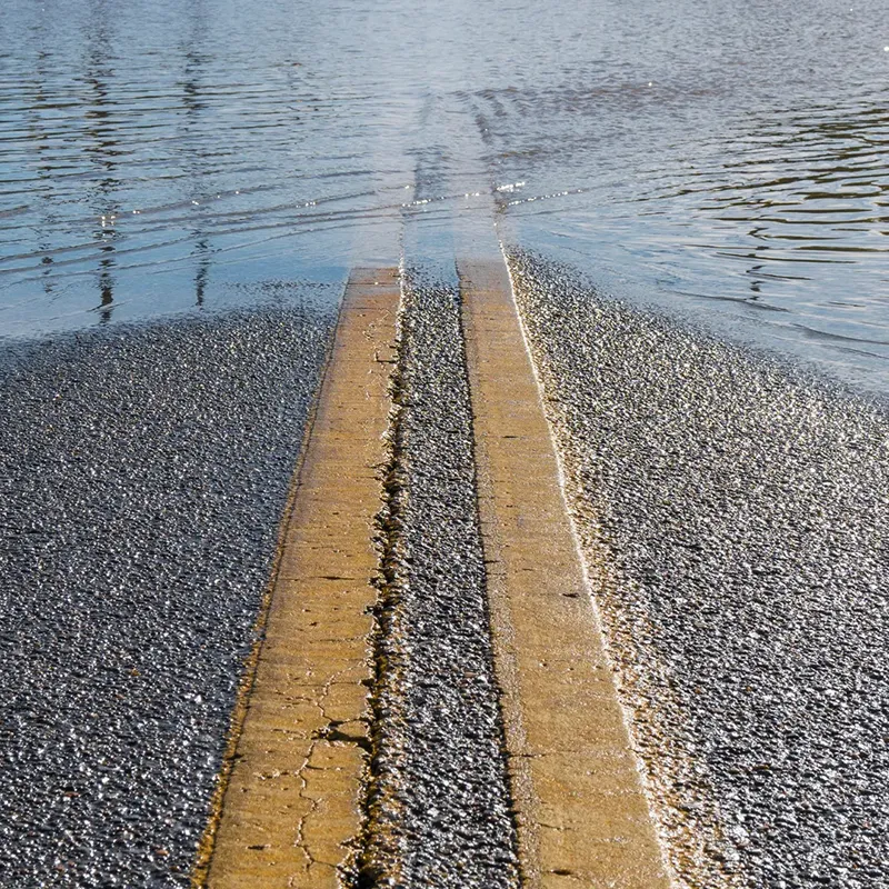 Double yellow center line of a flooded road