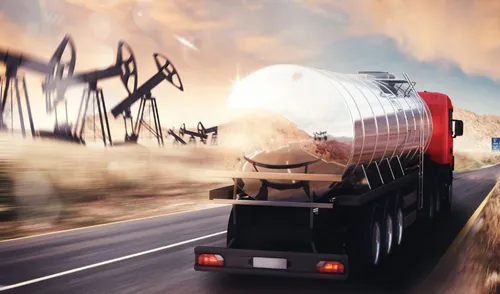 Tanker truck on road with derricks